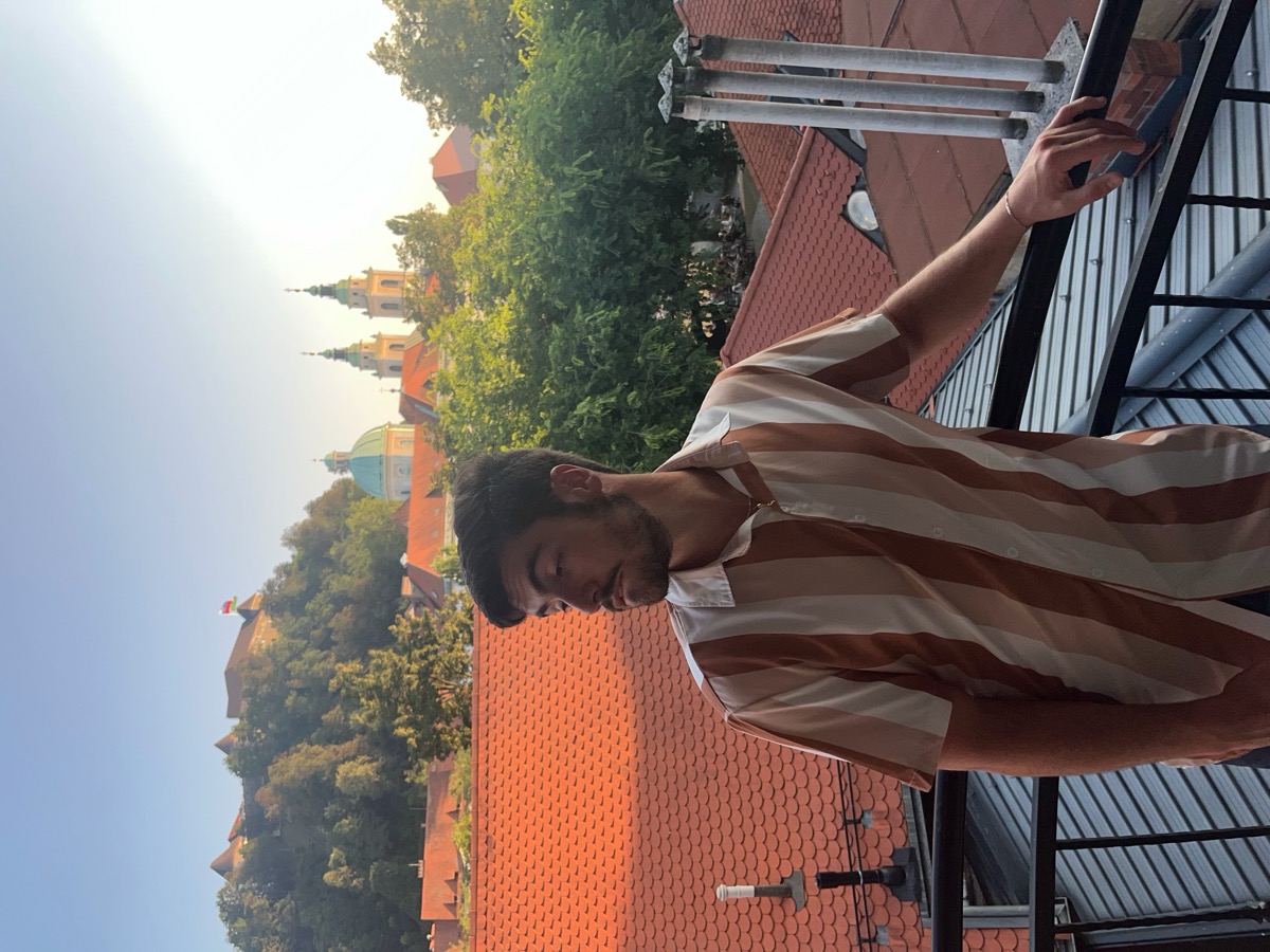 Matt Kahler posing on a balcony over European rooftops