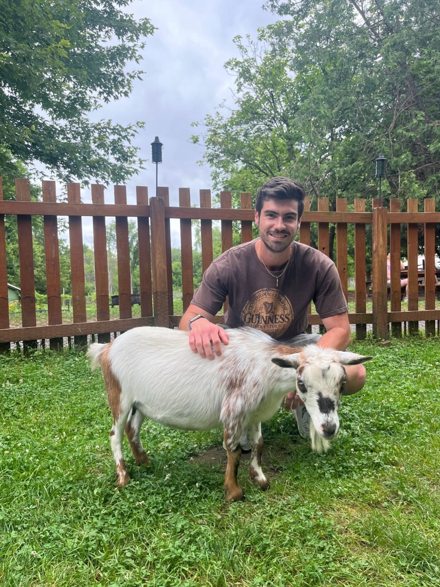 Matt Kahler petting a small goat