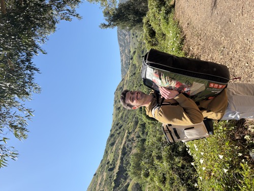 Matt Kahler hauling a giant tent bag on a hiking trail